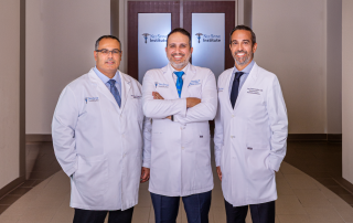 Dr. Saleh, Dr. Ahmadian and Dr. Deukmedjian standing in the hallway at NeuSpine Institute